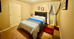 a bedroom with a bed and a window at Your Lawrenceville home in the heart of it all in Lawrenceville