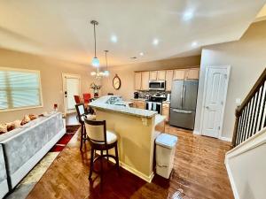 a kitchen with a bar and a living room at Your Lawrenceville home in the heart of it all in Lawrenceville +11 photos