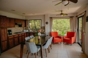 a kitchen and dining room with a table and chairs at Eco Boutique Hotel Vista Las Islas Reserva Natural in Paquera