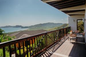 a balcony with a view of the water at Eco Boutique Hotel Vista Las Islas Reserva Natural in Paquera