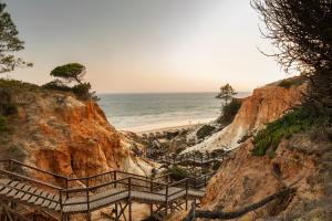 a staircase leading to a beach on a cliff at EPIC SANA Algarve Hotel in Albufeira