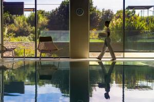 a man walking by a window in a building at EPIC SANA Algarve Hotel in Albufeira