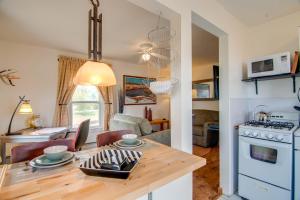a kitchen and living room with a table and a dining room at Red Gates Cottage 3 Miles to University! in Laramie
