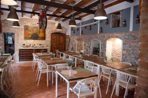 a restaurant with wooden tables and white chairs at Fra Diavolo in Diano Marina