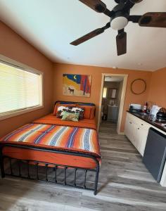 a bedroom with a bed and a ceiling fan at Cabin at the Hill, Close to Big Bend National Park and Terlingua Ghost Town in Terlingua
