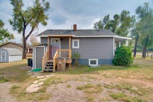 a tiny house with a porch and a deck at Red Gates Cottage 3 Miles to University! in Laramie