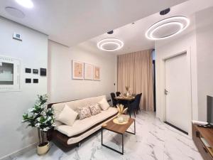 アブダビにあるElegant Pool-View 1BR Near Cleveland Clinicのソファとテーブルのあるリビングルーム