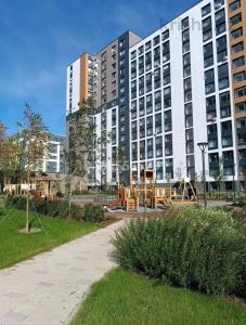 a large building with a playground in front of it at Современный 3х комнатный апартаменты на Туране возле Барыс Арена in Astana