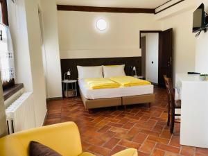 a bedroom with a bed with yellow sheets on it at Agriturismo Cascina Costa in Cassago Brianza