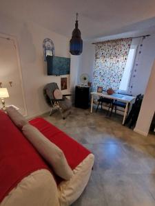 a bedroom with a red bed and a living room at Apartamentos Málaga Centro Hernán Ruiz de 4 a 8 Personas in Málaga