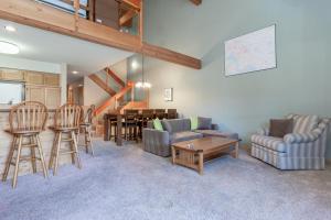 a living room with a couch and chairs and a table at Snowcreek IV 588 in Mammoth Lakes