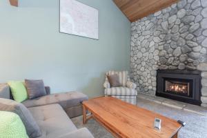 a living room with a couch and a fireplace at Snowcreek IV 588 in Mammoth Lakes
