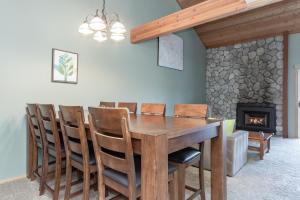 a dining room with a table and chairs and a fireplace at Snowcreek IV 588 in Mammoth Lakes