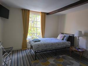 a bedroom with a bed and a large window at Family Room - The Unicorn Hotel in Llanidloes