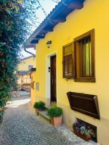 a yellow building with plants on the side of it at MH-Luxury Apartments in Cavalese