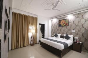 a bedroom with a large bed in a room at Hotel Luck Recdancy mahipalpur in New Delhi