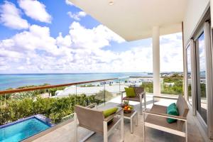 a balcony with a view of the ocean at Villa Skyline with stunning Ocean View in Turtle Cove