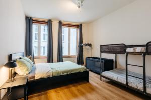 une chambre avec deux lits superposés et un bureau dans l'établissement Maison du Beffroi de Mons centre ville, à Mons