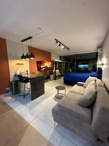 a living room with a couch and a bedroom at Foster Studio - Park 3 in Buenos Aires