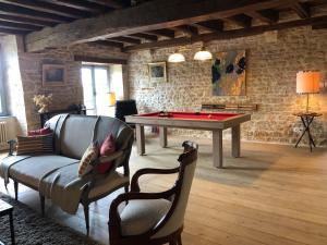 a living room with a pool table and a couch at Armance in Mont-Saint-Jean