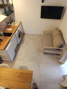 a small kitchen with a couch and a microwave at Borgata Relax in Syracuse