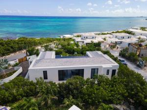 an aerial view of a white house on the beach at Skyline Villas - Villa Luna Oceanfront with Private Pool in Providenciales
