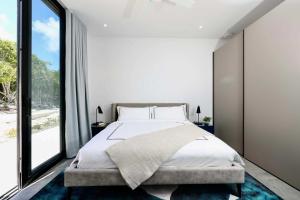a bedroom with a large bed and a large window at Skyline Villas - Villa Luna Oceanfront with Private Pool in Providenciales