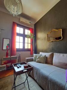 a living room with a couch and a table at Habitación privada, solo Damas "Alma de mujer" in Buenos Aires