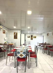 a dining room with tables and chairs in a restaurant at Bulvar Hotel & Hostel in Samarkand