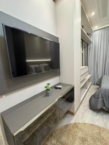 a living room with a large flat screen tv on a wall at Apartment 403 withoeft in Pomerode