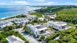 an aerial view of a house with the ocean at Villa Venus with Private Pool Oceanfront in Turtle Cove