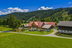 an aerial view of a house with a green lawn at Forsterhof in Ramsau am Dachstein