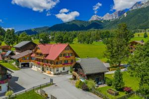 an aerial view of a house with mountains in the background at Forsterhof in Ramsau am Dachstein