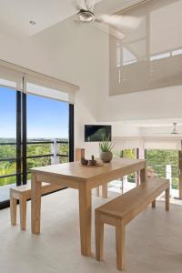 a dining room with a wooden table and bench at Vista Popoyo 3BR Coastal Retreat with Surf & Mangrove Views in Popoyo +34 photos
