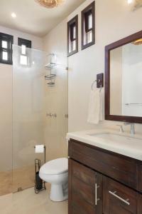 a bathroom with a toilet and a sink and a shower at Vista Popoyo 3BR Coastal Retreat with Surf & Mangrove Views in Popoyo