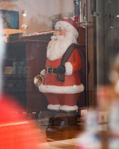 a santa claus standing in front of a tv at BinderS Budget City-Mountain Hotel in Innsbruck +91 photos