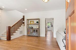 a living room with a staircase and a mirror at Witek Rinker House in Brevard