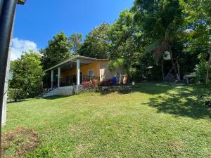 a house with a yard in front of it at Casa Cahuí in El Remate