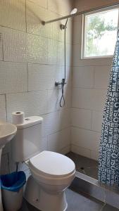 a bathroom with a toilet and a shower curtain at Camping Campeon in Salto del Laja +16 photos