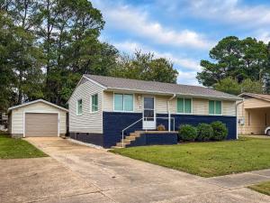 a white and blue house with a garage at Franklin in the Middle in Jonesboro