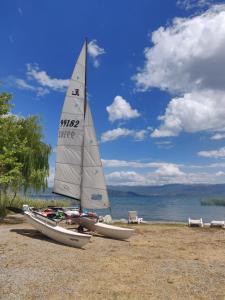 a sail boat sitting on the shore of a beach at Urban Vibe Apartments 2 in Skopje