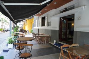 a row of tables and chairs outside of a restaurant at Copacabana Blue Hotel in Rio de Janeiro
