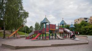 a park with a playground with a slide and slides at Comfort Us 2 - Cozy Private Home in Uppsala