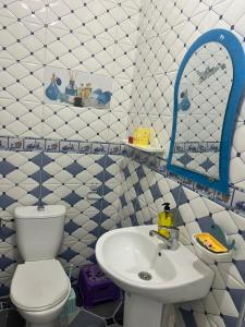 a bathroom with a toilet and a sink at Casa Youssef 1 in Asilah +11 photos