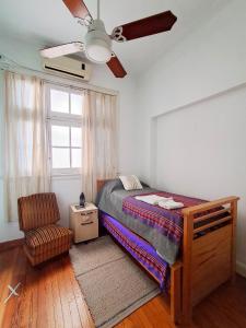 a bedroom with a bed and a ceiling fan at Habitación privada, solo Damas "Alma de mujer" in Buenos Aires +14 photos