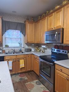 Una cocina con gabinetes de madera y un horno de estufa. en The Cardinal Room, en Raleigh