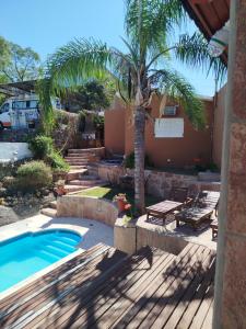 una casa con una palmera y una piscina en Chalet " La Maruca ", en Villa Carlos Paz 39 fotos más