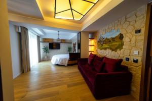 a living room with a couch and a bedroom at Hotel Castel Suceava in Suceava