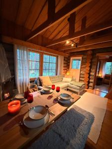 a living room with a table with plates and wine glasses at Villa Kelo - Casual Luxury in Lapland, Salla in Salla