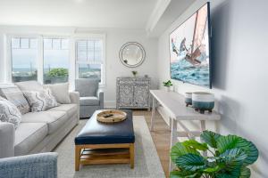 a living room with a couch and a table at Thomas Sea Suites Penthouses in Plymouth